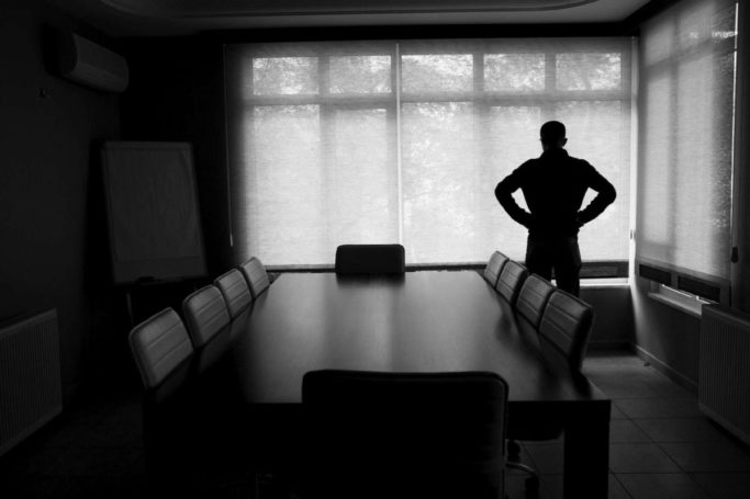 bankruptcy-man-alone-conference-room Man influenced by bankruptcy