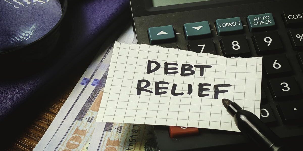 debt-relief Debt Relief paper note on a calculator