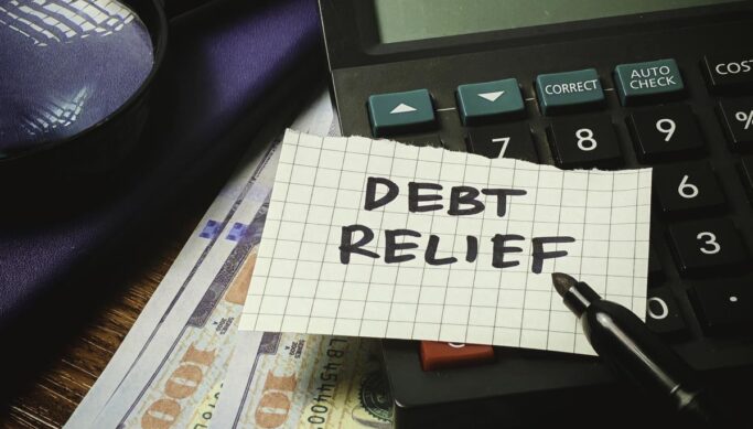 Debt Relief paper note on a calculator