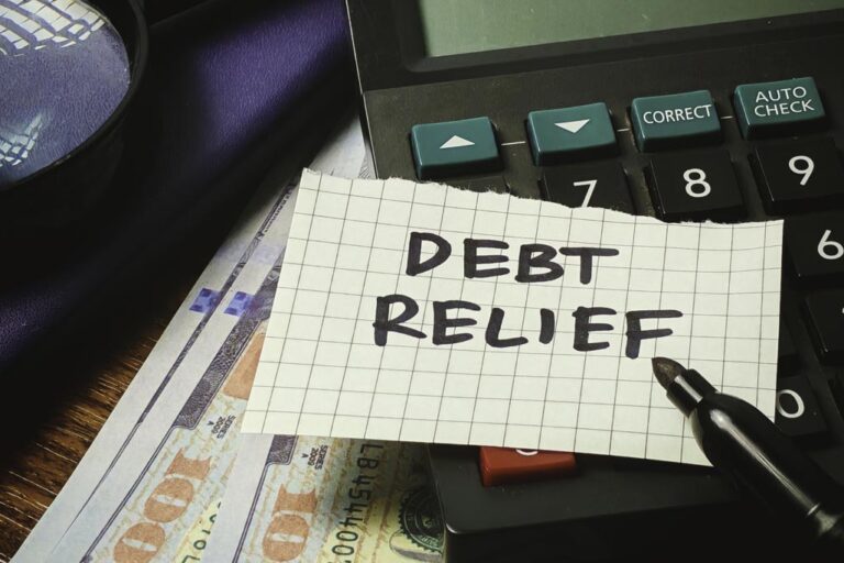 Debt Relief paper note on a calculator